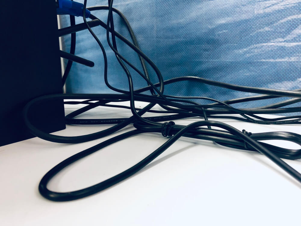 tangled cables around the desk